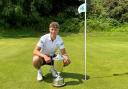 Ed Featherstone gets his hands on the historic Norfolk Amateur Championship trophy for the first time