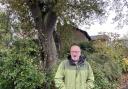 Gary Saunders has faced numerous attempts to cut off parts of a protected oak which sits within his property