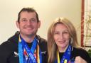 Ian and Angela Bell proudly displaying their Big City Marathon medals.