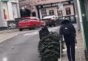 A police officer was seen dragging a town's stolen Christmas tree