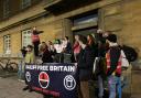 Acorn protestors stand outside City Hall during a demonstration against the use of bailiffs