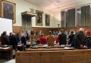 Councillors stand as lord mayor Paul Kendrick arrives at Norwich City Hall during a full council meeting this week