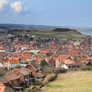 A view over the rooftop's of Sheringham from Beeston Bump. Weybourne and Salthouse can be seen in the distance.