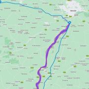 A map provided by National Grid shows the proposed route of the new power line, in purple. The line itself would run somewhere within the width of the purple band. Norwich can be seen to the north-east. The blue lines are existing cables.
