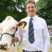 Essex dairy farmer John Smith with Katie, his supreme champion Holstein dairy cow, at the 2022 Royal Norfolk Show