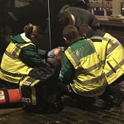 Norwich SOS Bus staff look after a woman on the floor outside of a bar