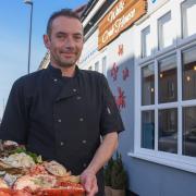 Scott Dougal with a seafood platter outside Wells Crab House, which he runs with his wife Kelly
