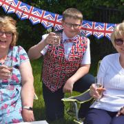 Zoe and Samuel Parle and Lynne Bland toast the Queen
