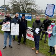 Jo Rust (left) with campaigners outside the QEH and North West Norfolk MP James Wild (centre, rear)