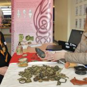 Suffolk County councillor Melanie Vigo di Gallidoro (left) and Anna Booth, Finds Recording Officer with Suffolk County Council’s Archaeology Service, with a replica of the same type of axe reported on the finds day.