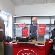 First customer for the new pop-up post office Lisa Ashby with temporary postmaster Kevin Salmon and Hethersett's County Councillor David Bills.