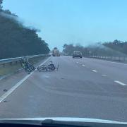A number of bicycles have fallen off a roof rack on the A11