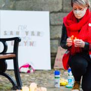 Jo Rust lights a candle in memory of Sarah Everard. Pictured: Ian Burt