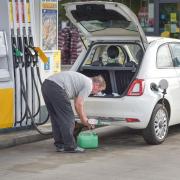 A man fills up a jerry can with extra fuel.   Picture: Sarah Lucy Brown