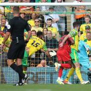 Emmanuel Dennis of Watford scores his sides 1st goal during the Premier League match at Carrow Road