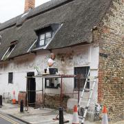 Work being carried out to restore the decorative pargeting on the 500-year-old Bishop Bonner's Cottage in Dereham. Picture: DENISE BRADLEY