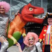 Pride town crier, Mike Wabe, launches Norwich Pride with a special cry and drag queens the Squirrels, MSK, left, and Miss Crystal, by the GoGoDino Prideosaurus at the Forum. Picture: DENISE BRADLEY