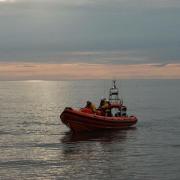 Lifeboat volunteers came to the aid of three people cut off by the rising tide at Brancaster.