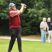 A golfer takes a swing at 2014's Annual Charity Golf Day, in Swaffham.