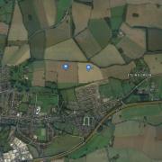 An aerial view of the two fields the council is considering purchasing - marked with two icons in the centre of the image. The land lies just north of the town's Etling View housing development.