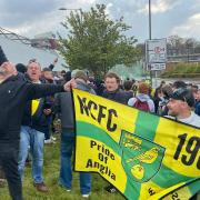 Norwich City fans celebrate the Canaries clinching the Championship title outside Carrow Road.