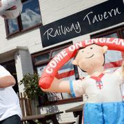 Paul Sandford at the Railway Tavern in Dereham has had world cup t-shirts for his customers marking the fixtures for England and Portugal. With him is daughter Martha Sandford. Picture: Matthew Usher.