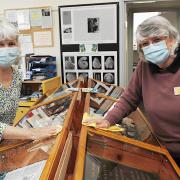 Margi Blunden (left) and Sheila Kent dust off a display at Hunstanton Heritage Centre ready for its reopening