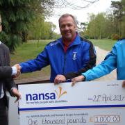 NANSA Trustee Tom Garrod receives a cheque from Swaffham Golf Club Captain Keith Edmond and Head PGA Professional Alan Wright. Picture: NANSA