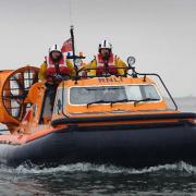 A nine-year-old boy was rescued by a jet skier after being swept out to sea on an inflatable boat.