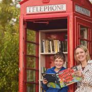 The phone box at Swanton Morley village hall has been converted into a book exchange. Pictured are Faye le Bon and her son George (10). Picture: Ian Burt