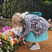 Mourners gather to lay flowers and pay their respects at the Sandringham Estate in Norfolk following the death of Queen Elizabeth II on Thursday. Picture date: Friday September 9, 2022.