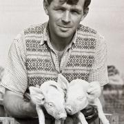Eric Cook farmed wheat, barley, oats, beans, sugar beet, and potatoes and kept cattle, pigs, and chickens. He is pictured here holding what might possibly be the world's most adorable piglets
