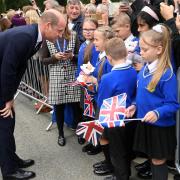 The Prince of Wales meeting students from Howard Junior School in King's Lynn at the gates of Sandringham House in Norfolk