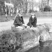 Two girls pictured Caister in April 1961, where they seem to be catching tadpoles or other aquatic wildlife.