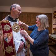 Revd Canon Dr Andrew Braddock being fitted for the Birkbeck Cope ahead of his installation as Dean of Norwich.