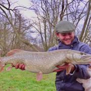 Keeper James Buckley with a pike and, of course, Bailey the dog!