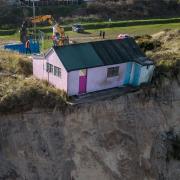A home in Hemsby sits perilously close to the cliff edge following a recent storm and high spring tides that battered the east coast of Norfolk