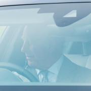 King Charles III waved at onlookers as he drove to the church in Sandringham
