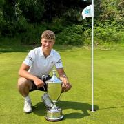 Ed Featherstone gets his hands on the historic Norfolk Amateur Championship trophy for the first time