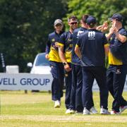 Norfolk players congratulate Ryan Findlay after a brilliant caught and bowled against Suffolk