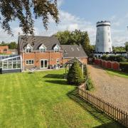 A four-bed property next to the historic Saham Mill is for sale