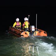Two people were rescued off the Norfolk coast after becoming stranded by the high tide