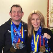 Ian and Angela Bell proudly displaying their Big City Marathon medals.