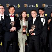 Ross Stringer (centre-right) holding his Bafta after winning the British Short Animation award