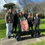 Family, friends and pro skater Chewy Cannon, with a photo of Ollie Nicholls, at the unveiling of the new skateboard memorial bench in Normanston Park, Lowestoft. Picture: The Nicholls family
