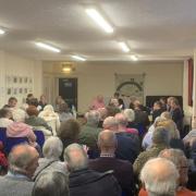 People attend a public meeting in Grimston to discuss sewage issues in the village
