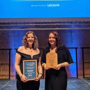 Rebecca Fox and Vicki White from Warner Bros. Studio Tour London – The Making of Harry Potter celebrate winning the Large Visitor Attraction of the Year award, sponsored by Howes Percival, at the East of England Tourism Awards 2023-2024