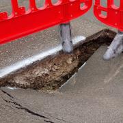 Another pothole has opened up in Norwich's Elm Grove Lane. Inset right: Jo Hiller and county councillor Steve Morphew
