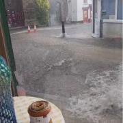 Water rushing down St Nicholas Street in Diss