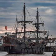 Hundreds of people gathered at a seaside pier for the arrival of a replica 17th century ship